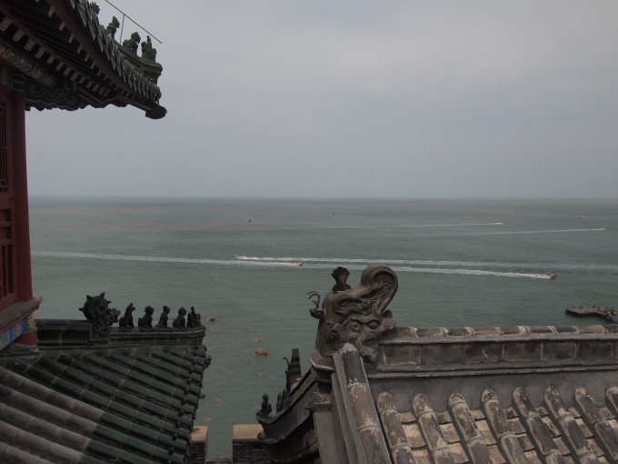 然后,联系帅哥老板把我们送到月牙湾。 月牙湾是因为地形恰似一道弯月而得名,这里的特色是球石滩,而非一般的沙滩。球石圆润,走在上面不咯脚,很舒服。只是有些地方石块很小,脚底的锐度感受就明显很多。 Tips:海滩球石是由于地壳运动地表隆起后造成附近山峦的岩石脱落,石块置身于弧形的海滩,经过海浪无休止的冲刷磨砺而逐渐变圆形成球石。因石英岩中夹杂了铁、锰、锌等杂质,因而呈现出各种颜色。 所以坐在海滩上挑捡球石也是一种乐趣,挑完后拍照留念,留给下一个发现者像我一样欣赏他们。 如果七、八月份来,月牙湾肯定很受欢迎,那